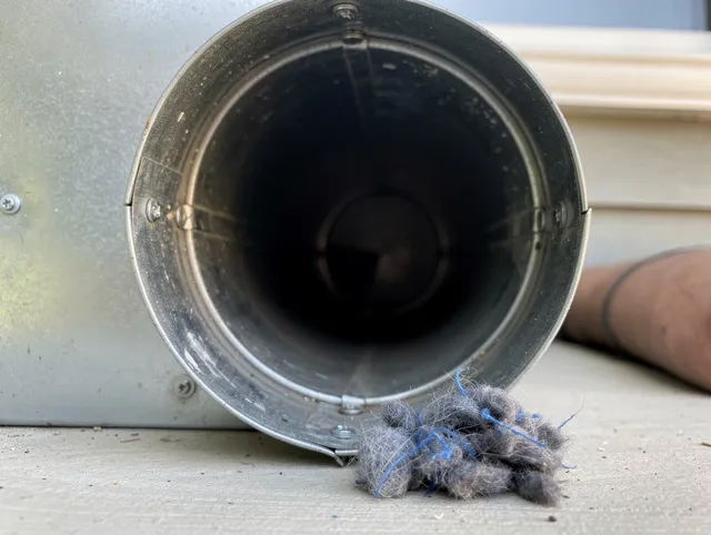 Laguna Niguel Dryer Vent Cleaning technician using specialized equipment to clear severe dryer vent blockage in Laguna Niguel